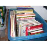 A plastic box containing various volumes on trains