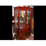 A reproduction oriental two door display cabinet w