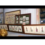 A cluster of framed cigarette cards and postcards