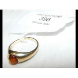 A lady's gold and amber ring