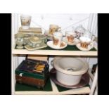 Two shelves of assorted crested ware, cased cutler
