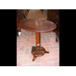 A 19th century oval rosewood wine table