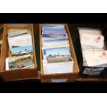 Two boxes of ship themed postcards and a box of as