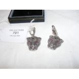 A pair of silver leopard head earrings set with ru