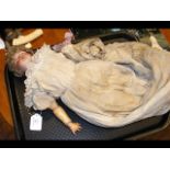 An antique bisque head doll with composite body