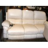 A three seater cream leather electric reclining se