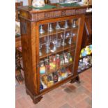 A stained oak display cabinet with single lead gla