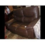 A two seater brown leather settee