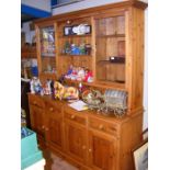 A large farmhouse pine dresser, featuring open she