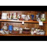 A wealth of Devon ware ceramics - on two shelves