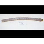 A lady's 9ct gold and diamond bracelet - the total dia