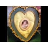 An elegant miniature portrait in heart shape ormol