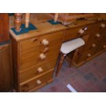 A pine knee-hole dressing table with mirror to bac