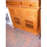 A teak side cabinet with grilles to lower cupboard
