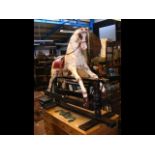 A vintage 4ft high painted rocking horse with leat