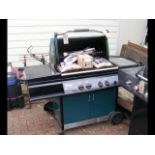 A Vermont large gas barbecue with utensils, cover