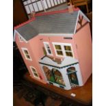 A model dolls house with shop front, complete with extensive furnishings - width 60cm