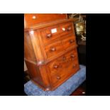 A miniature mahogany chest of four drawers with tu