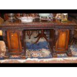 A Victorian carved oak break-front sideboard with