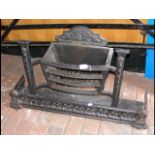 A wrought iron fire basket with fender