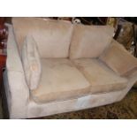 A two seater settee upholstered in oatmeal