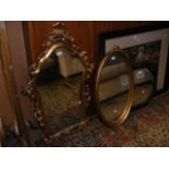 An oak octagonal wall mirror, two other mirrors in