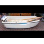 A 7.5ft plastic dinghy with Evinrude outboard and