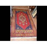 A Middle Eastern rug with geometric border and cen