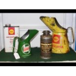 A Shell oil can together with three other oil cans