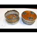 A pair of silver plated wine coasters with unusual