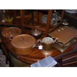 A copper food warmer together with other copper it