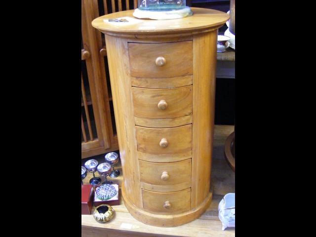 A cylindrical chest of six drawers