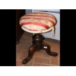 An antique revolving piano stool