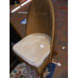 A Lloyd Loom nursing chair with upholstered seat