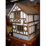 A Tudor style dolls house - length 53cm