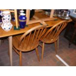 An Ercol light finish dining table - 150cm x 75cm,