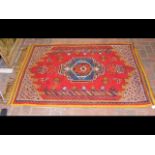 A hand woven Middle Eastern rug - 150cm x 110cm