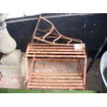 A wrought iron plant stand, together with an old s