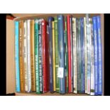 A box containing various collectable volumes on In