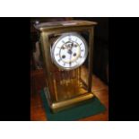 A 30cm high four glass mantel clock with visible e