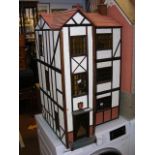 A Tudor style model dolls house, complete with extensive furnishings - width 50cm