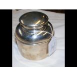 A silver tea canister
