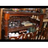 A mahogany extending dining table on reeded suppor