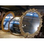 A gilt framed convex mirror together with two othe