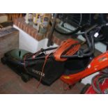 A Hayter mains electric rotary lawn mower with box