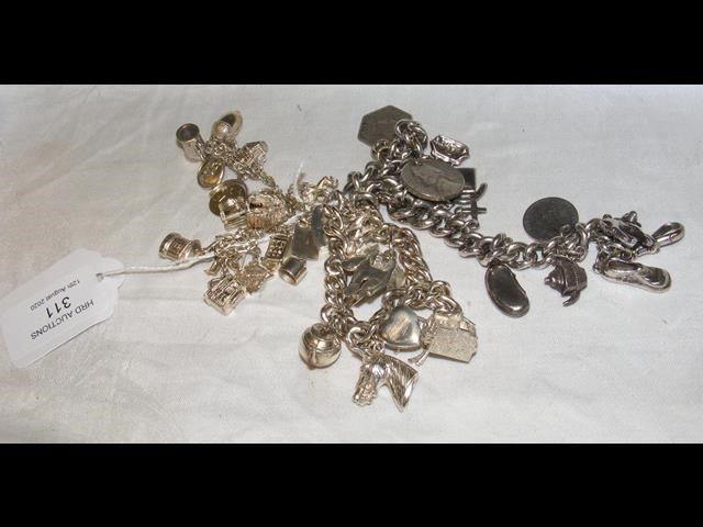 A heavy silver charm bracelet and one other