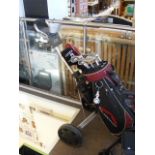 A golf bag containing various Callaway clubs, on t