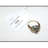 A 14ct gold diamond and sapphire and emerald ring