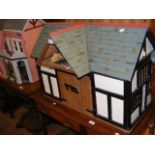 A model barn dolls house with pitched roof, complete with extensive furnishings - length 80cm