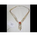 A silver and coral necklace